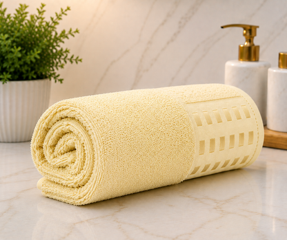 Pale cream yellow textured bath towel with elegant woven design